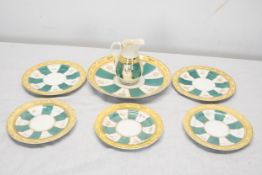 A hand painted 19th century green white and gold sunray pattern incomplete tea set. Largest plate