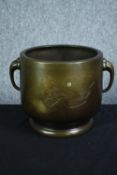 A large Chinese bronze twin handled urn with an etched decoration of pagoda in moonlight. H.23