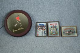 A vintage Johnny Walker light up advertising mirror along with three other mirrored advertising