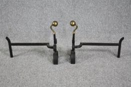 Pair of fire dogs. Twentieth century, wrought iron and brass. H.41 W.45 cm. (each)