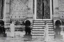 A large gilt framed photograph of monks at prayer at a temple. Modern print. H.116 W.147 cm.