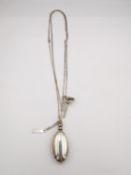 A Penhaligons silver necklace with oval scent bottle and miniature perfume funnel. Scent bottle