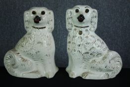 A large matching pair of Staffordshire dogs. No makers mark. H.34cm. Hand decorated and finished
