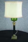 An old oil lamp converted to electric. With brass decoration and green glass tank. Circa 1900. H.