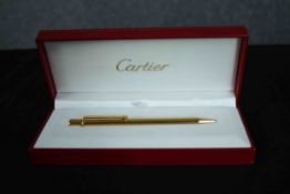 Cartier gold plated ballpoint pen in unused condition and still in original packaging box. Dated