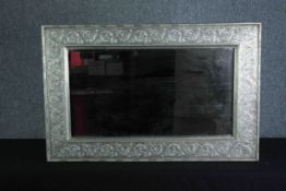 Wall mirror, embossed metal frame. H.62 W.94cm.