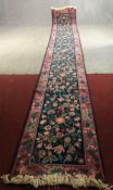 Runner, hand woven with Arts and Crafts floral motifs on a midnight field within complementary