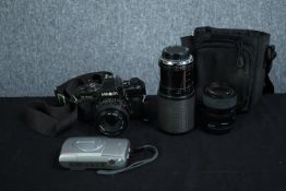 A Minolta X-700 35mm camera with three lenses and camera bag along with an Olympus camera. H.