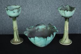 A pair of art pottery candle holders and a bowl. In the shape of cabbage leaves. Signed by the maker