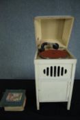 A children's or nursery gramophone record player with a collection of nursery rhyme records. 78 rpm.