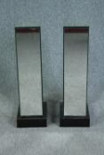 A pair of mirrored pedestals with hinged doors and storage shelves. H.74 W.25cm.