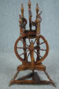 A 19th century elm and ash upright spinning wheel. H.91 W.50cm.