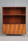 A vintage dwarf open bookcase on chrome supports. H.114 W.87 D.30cm.