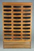 A mid century vintage draper's shop cabinet, full height with a bank of thirty glazed drawers. H.193