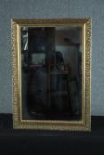 A contemporary gilt framed wall mirror with bevelled plate. H.76 W.53cm.