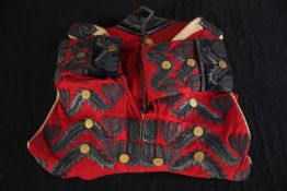 A well preserved military jacket from an unknown regiment. Mounted on a wooden display bracket.