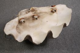 A Giant Clam (TRIDACNA GIGAS) half shell with light fittings attached to the inside. L.70 W.50cm.