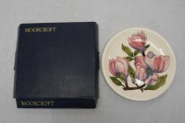 A large Moorcroft plate, boxed. 26cm diameter