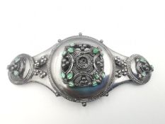 An Arts and Crafts silver and enamel belt buckle by Liberty and Co. The silver buckle adorned with