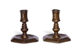 A PAIR OF 17TH CENTURY BRONZE CANDLESTICKS