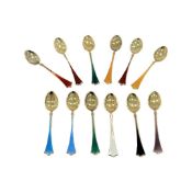 A SET OF TWELVE NORWEGIAN SILVER GILT AND ENAMEL SPOONS