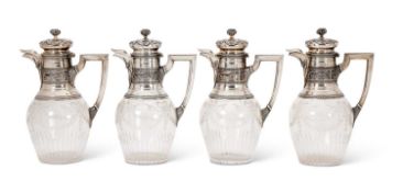 A FINE SET OF FOUR LATE 19TH CENTURY FRENCH SILVER AND CUT GLASS CLARET JUGS