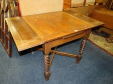 AN OAK DRAWLEAF BARLEYTWIST DINING TABLE