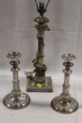 A GRECO ROMAN STYLE SILVER PLATED LAMP BASE TOGETHER WITH A PAIR OF SILVER PLATED CANDLESTICKS