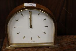 A DOME SHAPED SLIMLINE MANTLE CLOCK
