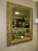 A VINTAGE GILT FRAMED AND MOULDED RECTANGULAR MIRROR 57 X 44 CM