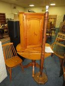A HONEY PINE DROPLEAF TABLE, TWO CHAIRS, A CORNER CUPBOARD AND STANDARD LAMP (5)
