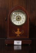 AN INLAID DOME SHAPED MAHOGANY MANTLE CLOCK