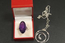 A LARGE SILVER RING AND A SILVER NECKLACE