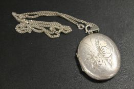 A LARGE HALLMARKED SILVER LOCKET AND CHAIN