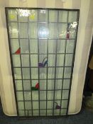 A GLAZED AND LEADED RECTANGULAR GLASS PANEL 115 X 58 CM