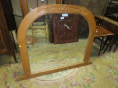 A CARVED ARCHED PINE OVERMANTEL MIRROR H-98 W-123 CM