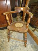 A VINTAGE CHILDS WINDSOR ARMCHAIR WITH HOLE