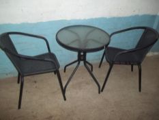 A MODERN PATIO TABLE AND TWO CHAIRS