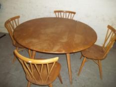 AN ERCOL BLONDE DROP LEAF TABLE AND 4 CHAIRS