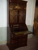 A LOCKING BUREAU BOOKCASE