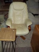 A LEATHER SWIVEL RECLINER CHAIR AND A WICKER TABLE