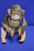 A VINTAGE BATTERY OPERATED SCARY LOOKING DANCING MONKEY