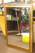 A FRAMED MIRROR 74 CM X 104 CM