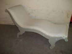 A WOOD AND FABRIC CHAISE LOUNGE