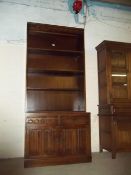 AN OAK BOOKCASE WITH LINEN FOLD DETAIL