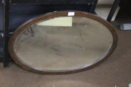 A FRAMED OVAL MIRROR