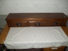 A MAHOGANY THREE DRAWER CUPBOARD