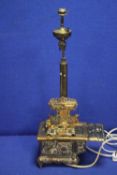 AN ANTIQUE BRASS LAMP IN THE FORM OF AN AGA
