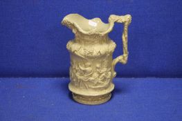 A DECORATIVE JUG WITH CLASSICAL DECORATION