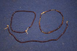 THREE GARNET BEAD NECKLACES WITH SILVER CLASPS